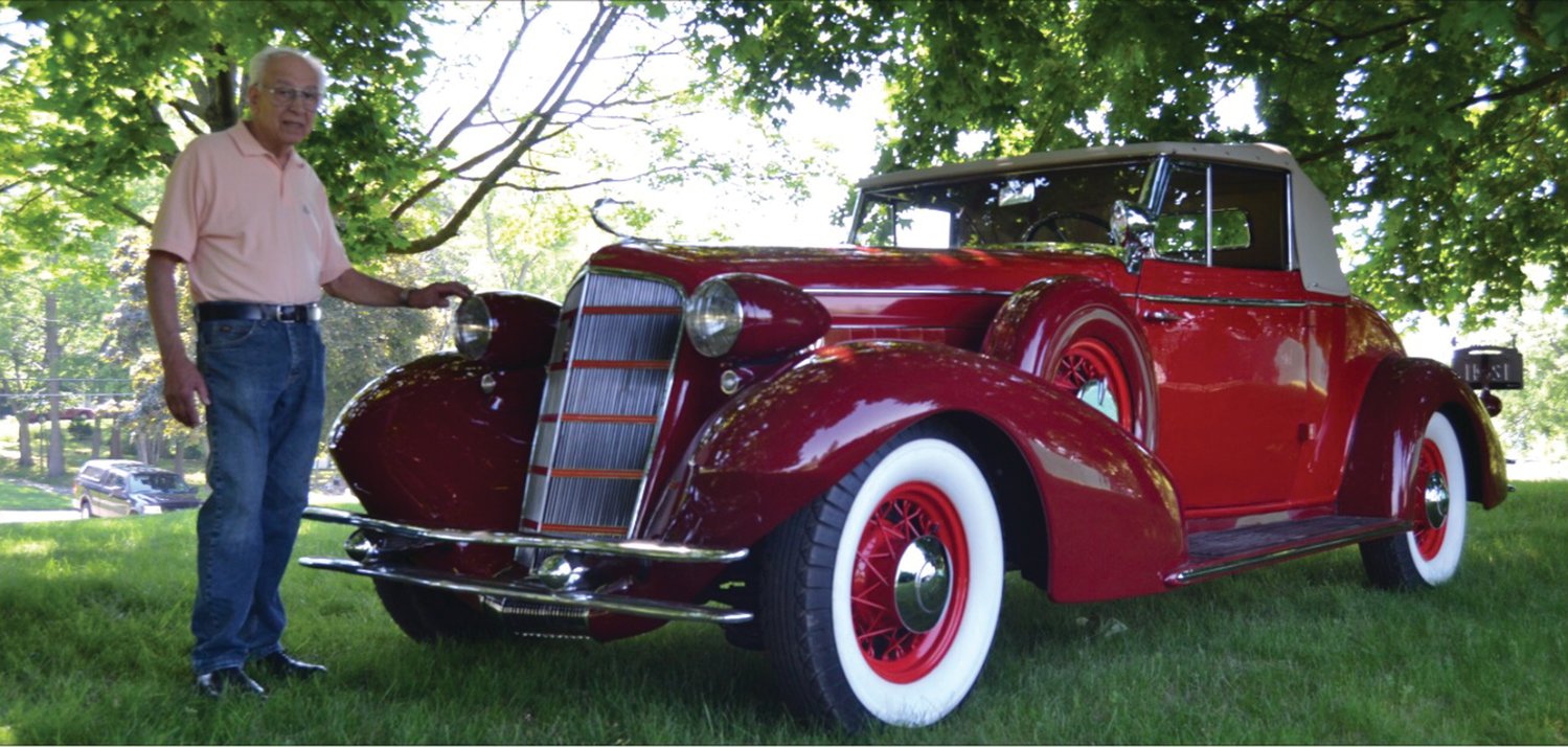 THE MAN AND HIS MACHINE: John Ricci poses for a photo with his fully restored 1934 Cadillac.
